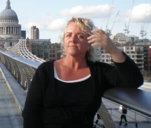 A woman stands on a bridge